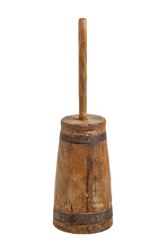 Old wooden butter churn with a tall plunger and metal bands, captured with a front view on a white background