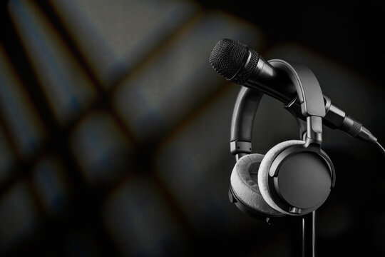 Microphone and headphones on stand for audio recording