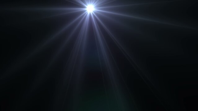 Bright glowing star light lens flare effect with blue rays on a dark background