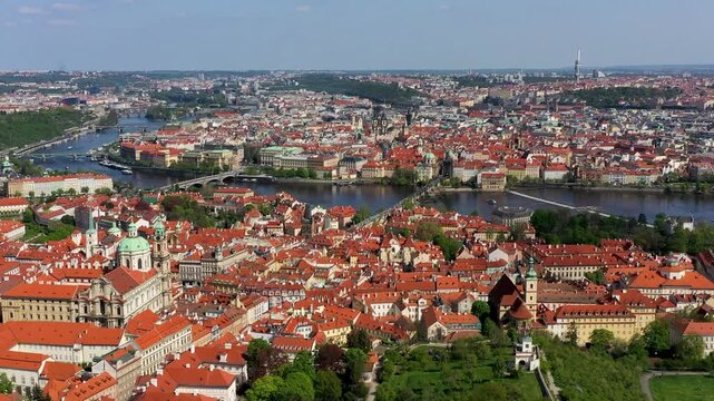View of Prague featuring vibrant rooftops on a sunny day in summer. Aerial view of Prague, Charles Bridge over Vltava river in Prague, Czechia. Old Town of Prague, Czech Republic.