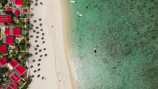 Beautiful Mauritius Island with gorgeous beach Flic en Flac, aerial view from drone. Mauritius, Black River, Flic-en-Flac view of oceanside village beach and luxurious hotel in summer.