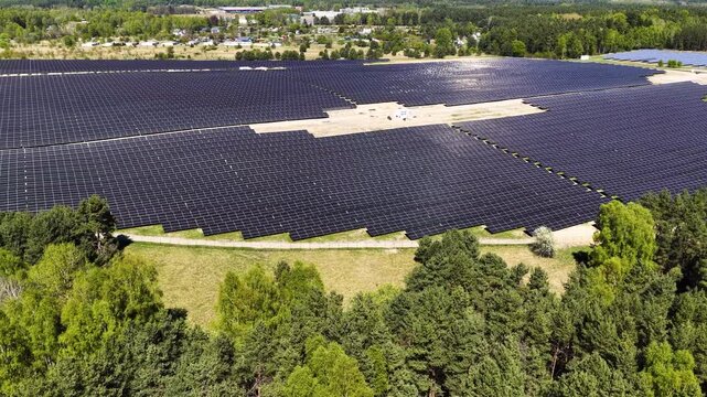 Solar panels generating renewable green energy and electricity in a wide open field, modern clean power technology infrastructure for sustainable energy production, environmental conservation 