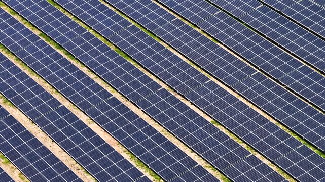 Solar panels generating renewable green energy and electricity in a wide open field, modern clean power technology infrastructure for sustainable energy production, environmental conservation 