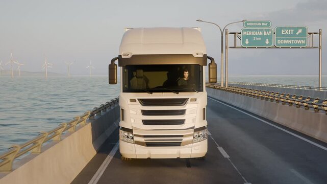 A centered leading camera faces a white semi truck as it drives along a long bridge over water, framing the vehicle head-on against the road and horizon.