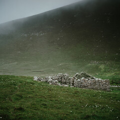Foula, Shetland, Scotland, United Kingdom, 5th July 2026, view of an abandoned croft with the hills leading to Da Sneug in the background © Electric Egg Ltd.