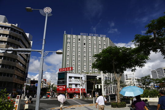 A busy street intersection with Hotel Rocore Naha in Okinawa.