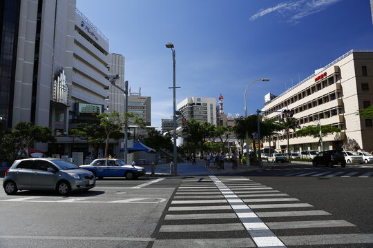 A wide city intersection in front of the Okinawa Prefectural Office in Naha.