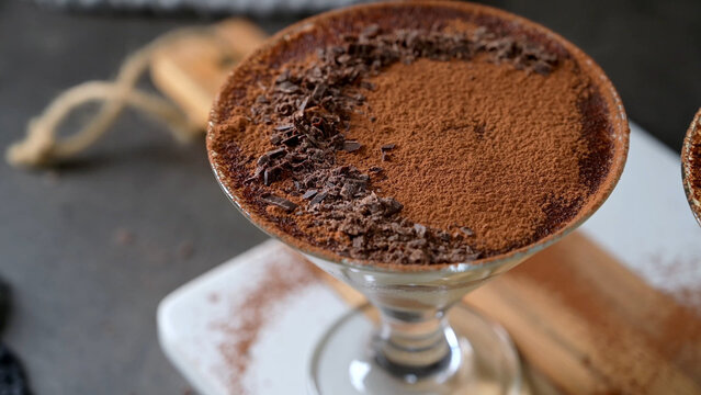 Classic Tiramisu Dessert in a stemmed cocktail  Glass with Cocoa Powder and Chocolate Shavings