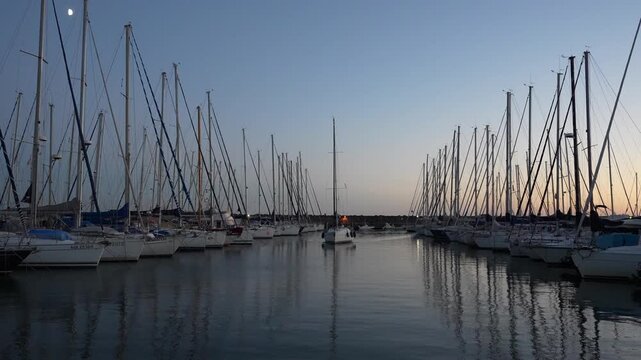 Sailing Yacht Moving Through Porto Turistico di Roma Marina at Sunset, Italy