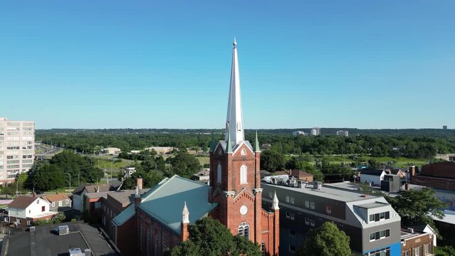Circular aerial shot of a church spire on St. Paul Street in St. Catharines, Ontario, Canada. The historic church building of worship, constructed in 1861.
