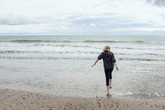 Teenage Girl Playing on the Beach In Donabate, Dublin, Ireland
