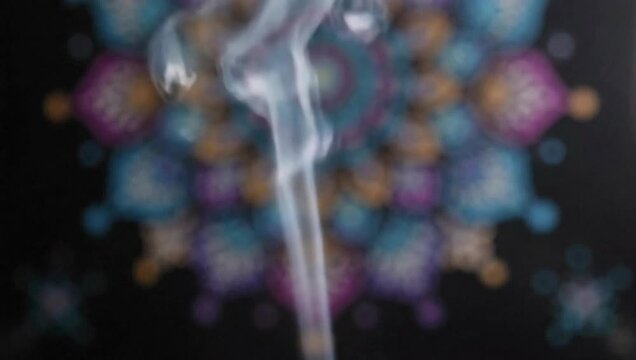 White smoke trail rising against colorful abstract mandala pattern background