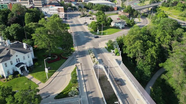 Aerial flying over Burgoyne Bridge and St. Paul Street landmarks towards downtown St. Catharines, Ontario, Canada on a sunny summer afternoon, August 2024.