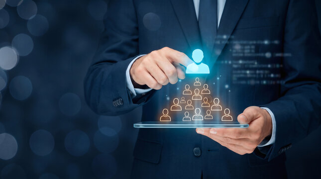 Businessman managing team hierarchy with digital interface on tablet for human resources and leadership concept
