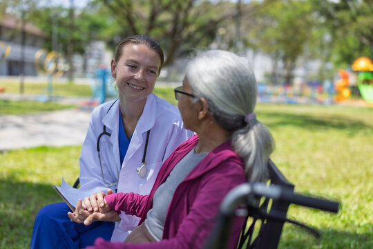 Doctor showing empathy and support to elderly patient outdoors