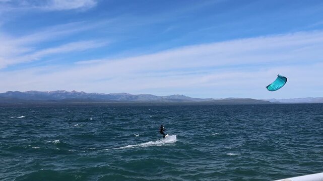 A person windsurfing on Lake Nahuel Huapi in San Carlos de Bariloche.
