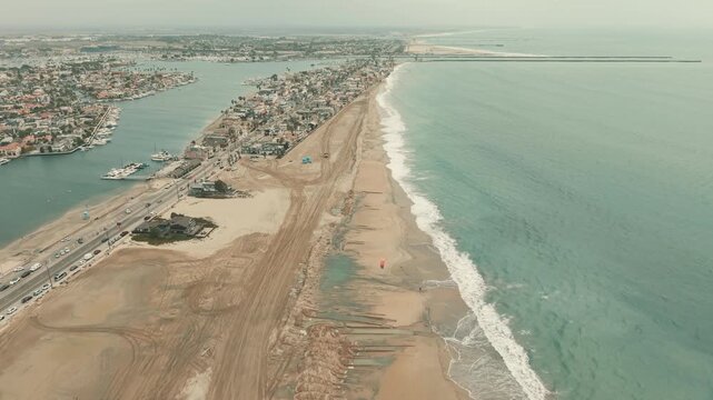 Drone view of Long Beach coastline with sand berms protecting homes from high tides and storm surf.