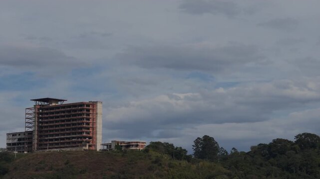 Abandoned Concrete Building Structure on Cloudy Hillside