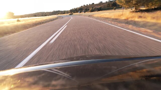 Driving Into Blinding Sunset on a Rural Two Lane Road