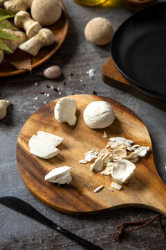 Fresh mushroom preparation on wooden board for cooking