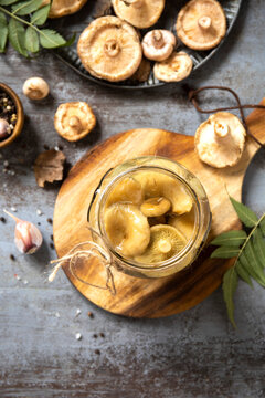 Marinated mushroom in jar with fresh seasonal ingredients