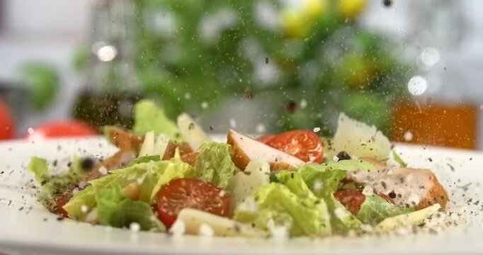 Caesar salad with falling spices in slow motion 1000 fps