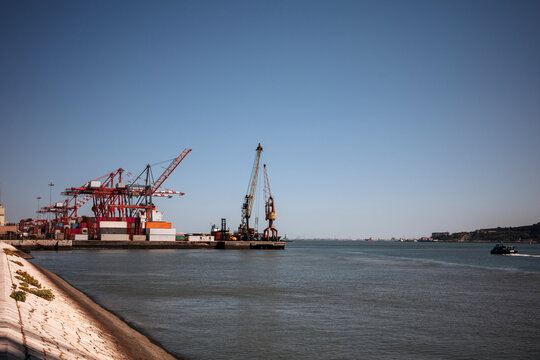 Cargo cranes at Lisbon port beside the Tagus river