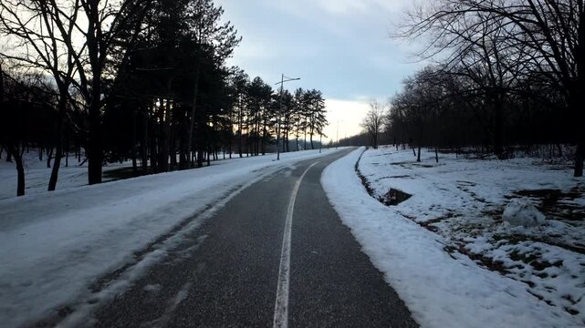 Snowy Bicycle Path Curving Through Winter Park