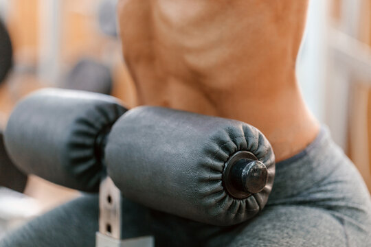 Close-up of athlete training abs on roman chair at gym