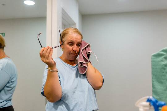 House cleaner wipe sweat during housekeeping task