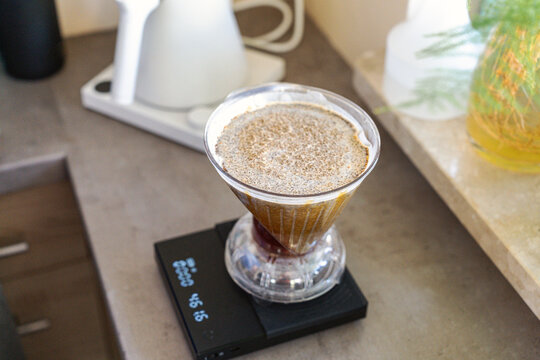 Pour over coffee brewing with filter dripper and scale