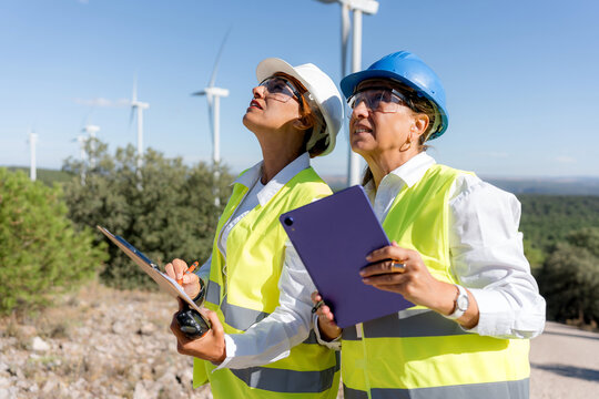 Women engineers inspect wind turbine field on-site