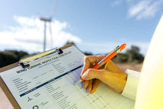Female engineer complete wind turbine inspection checklist
