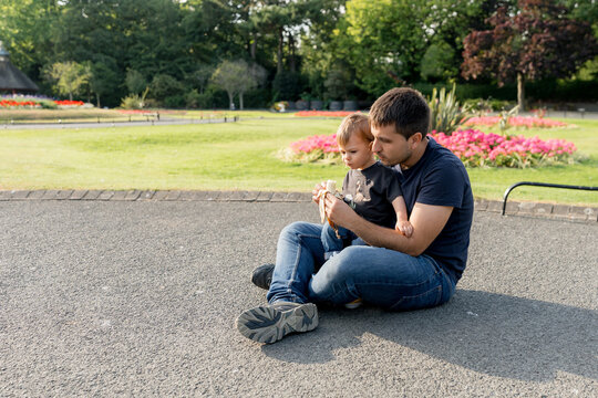 Father and child relax in St Stephen's Green Park