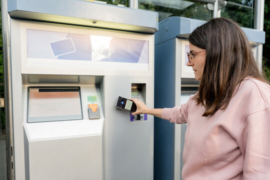 Woman use contactless card at Dublin LUAS ticket machine