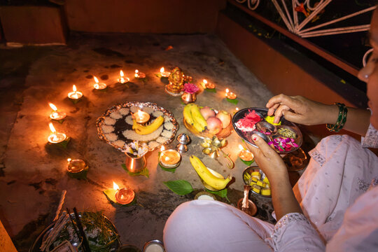 Hindu puja ceremony with diyas and offerings for Diwali