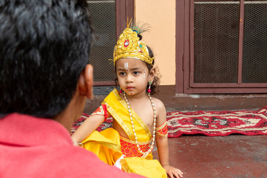 Young child in Krishna costume at Hindu festival ceremony