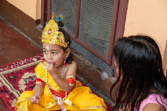 Young child in Krishna costume at Hindu festival ceremony