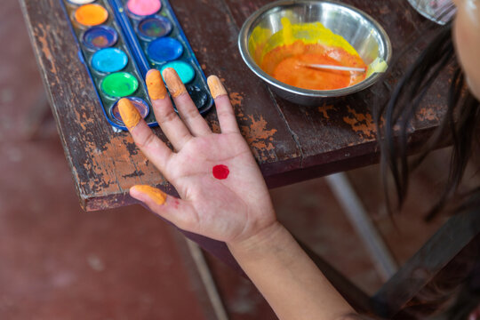Young hand with paint during Hindu festival ceremony