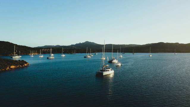 Sunset over a sheltered bay for mooring sailboats and catamarans