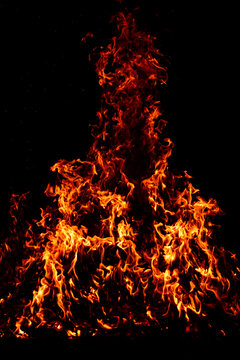 Glowing fire embers beneath blazing flames. Fire with glowing embers beneath flames. Blazing fire effect with glowing cinders. Fire blazing with flames in motion.