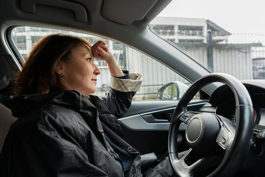 Mature woman driver resting in parked car