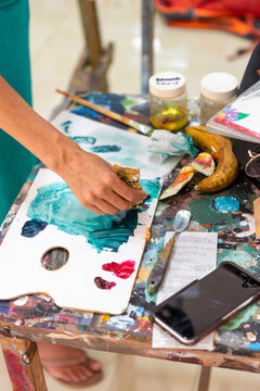 Woman painting with palette during art lessons at studio