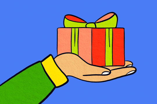Hand holding wrapped Christmas gift with festive ribbon