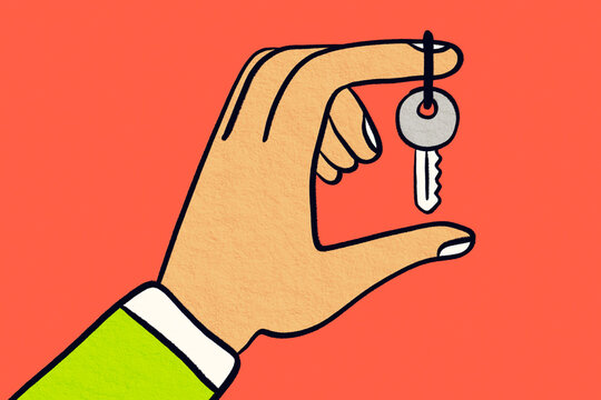 Hand holding key on finger against coral background