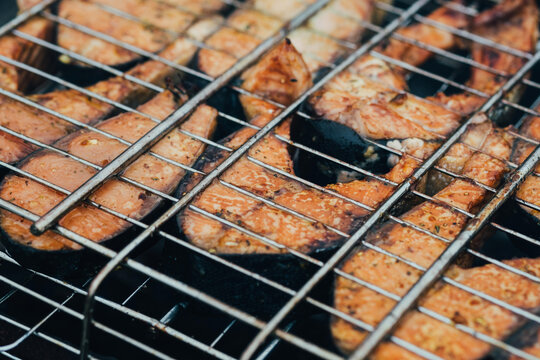 Grilled salmon fillet on barbecue rack with seasoning