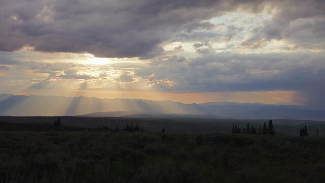 Cloudy mountain sunset fading from yellow to violet and red, time lapse, Utah