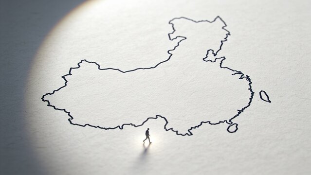 Displaying ink map outline on studio paper under spotlight, with mini figurine casting long shadow