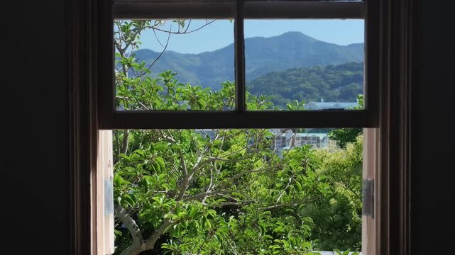 A smooth, slow top-down vertical camera movement reveals an antique, weathered wooden reed organ or harmonium placed inside a historic room with classic interior details, Japan, Nagasaki, Glover