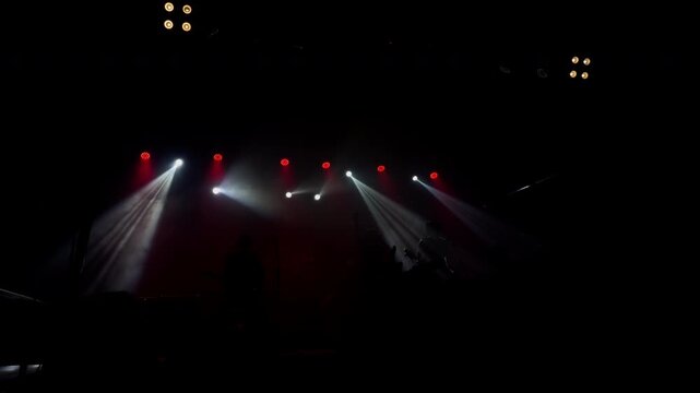Slow Motion Concert Stage with Red and White Light Beams